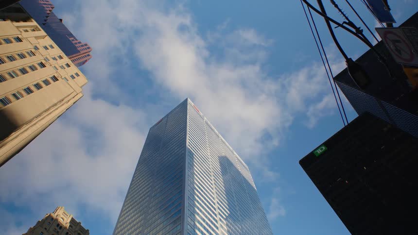 Blue skies reflect off a mirrored skyscraper downtown