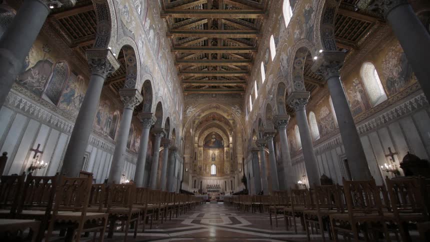 A church is empty with many pews