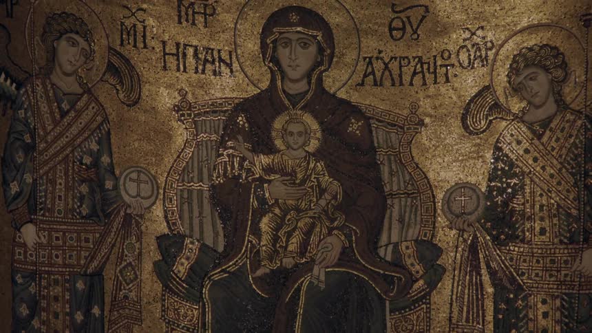 An image of the virgin mary holding jesus and surrounded by saints painted on a wall