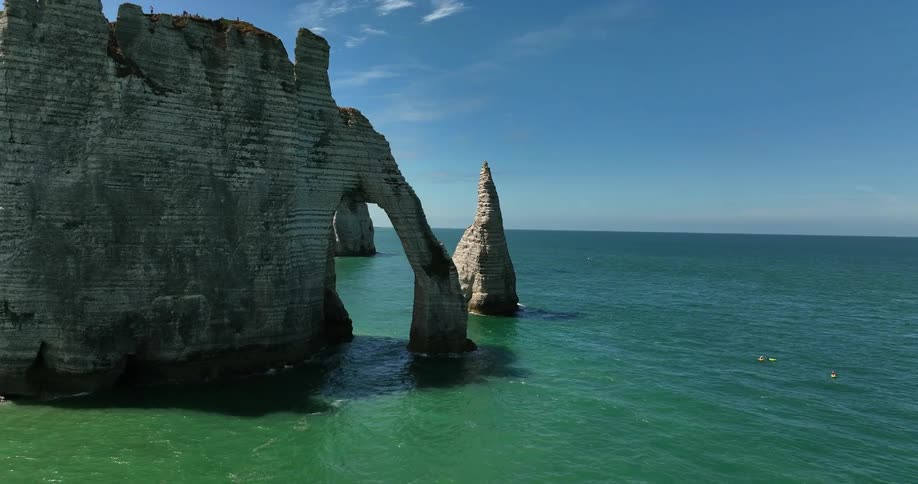 The arch and rock formation encircling the sandy beach at the chalk cliffs of porte daval etretat