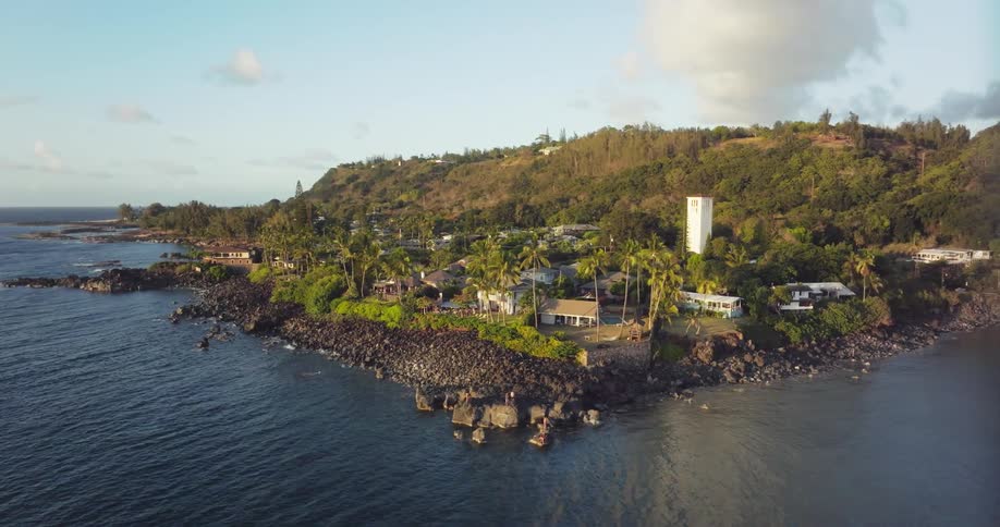 Aerial view of buildings in coastal town near the sea at sunset