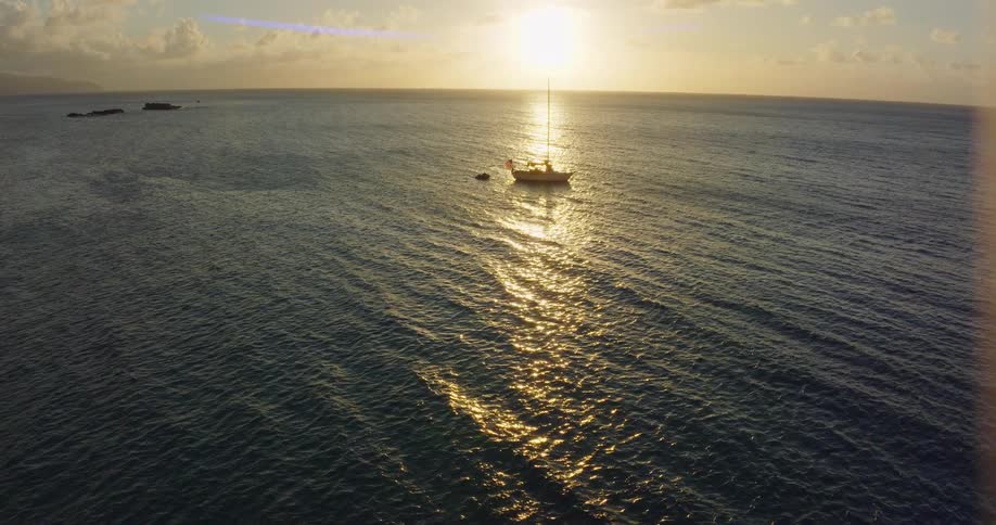 The sun is setting in the horizon of the ocean