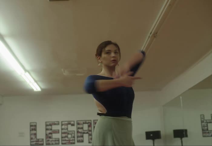 Young ballerina dancing in front of the mirror on a studio