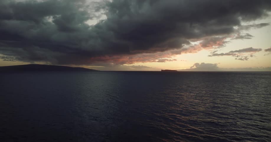 Aerial view of distant mountains or island on the horizon at evening