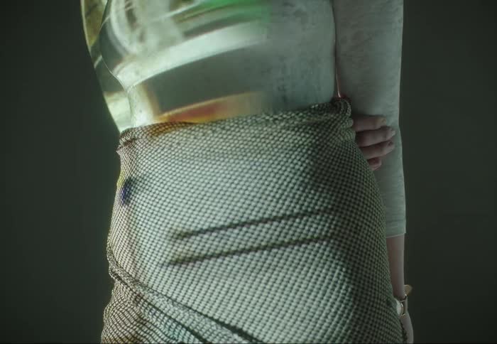 Woman stands as video of dancing ballerina is projected onto her clothes