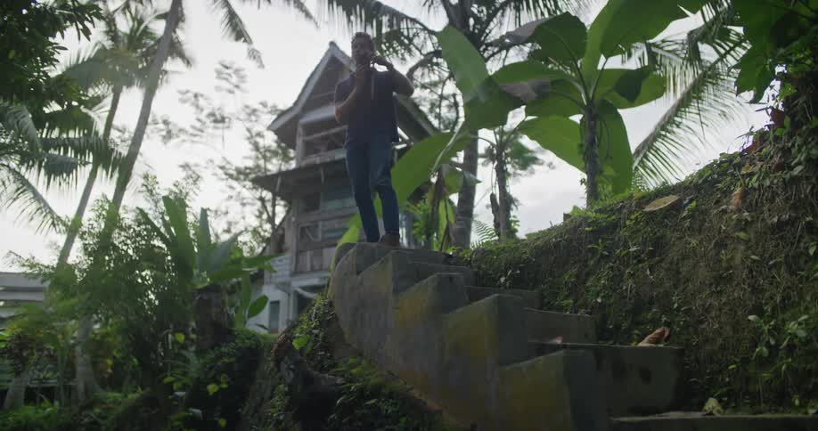 A man takes photographs on top of the stone steps