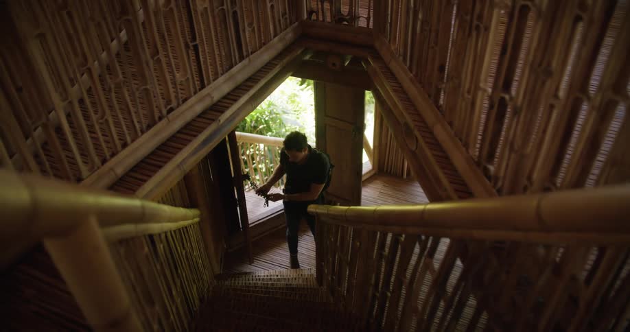A man is entering a building during the spring