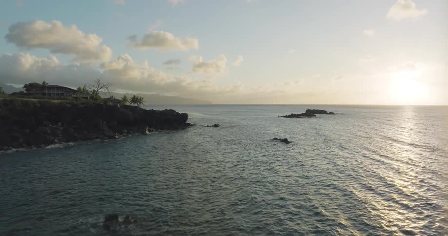 The rocky coastline of a land mass during the day