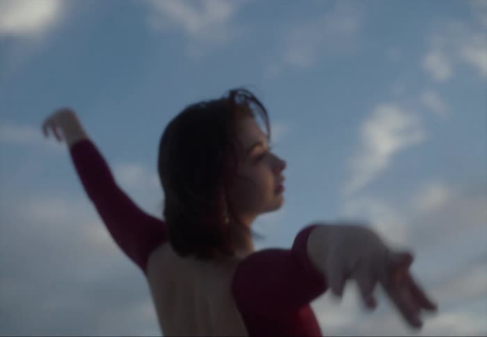 A woman is dancing ballet outside