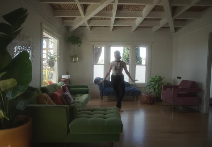 A ballet dancer practices in her home