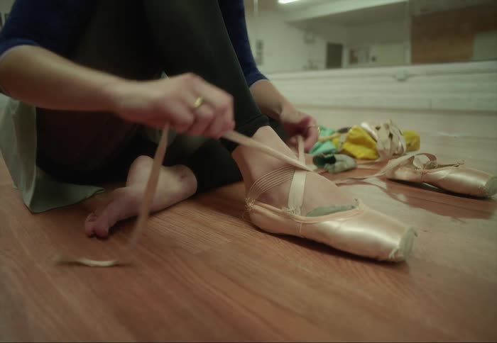 A woman putting on shoes