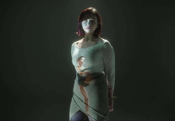 Projection of a ballerina on the body of a woman standing on a room looking at the camera
