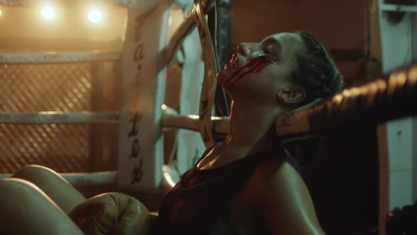 A woman is on the ground bleeding on the ropes
