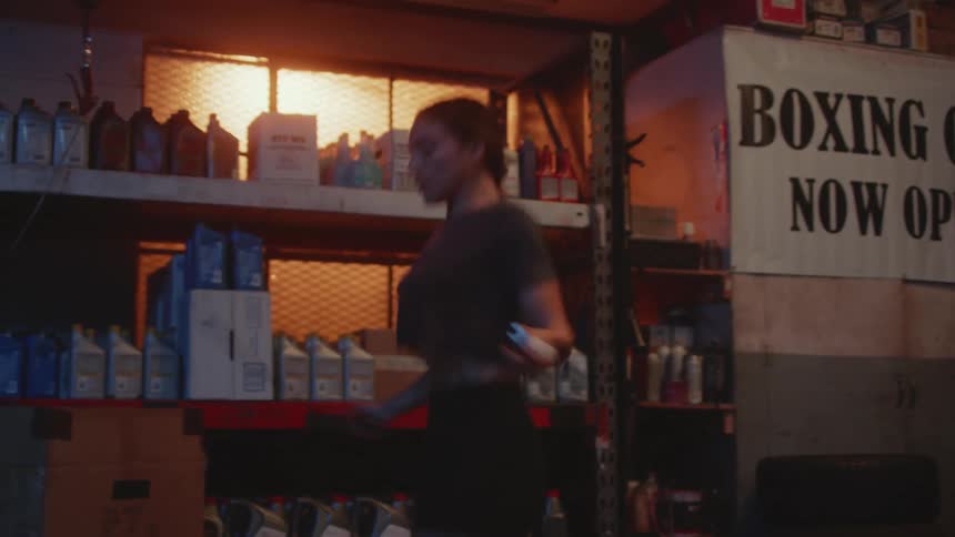 A woman jumps rope in a kitchen pantry