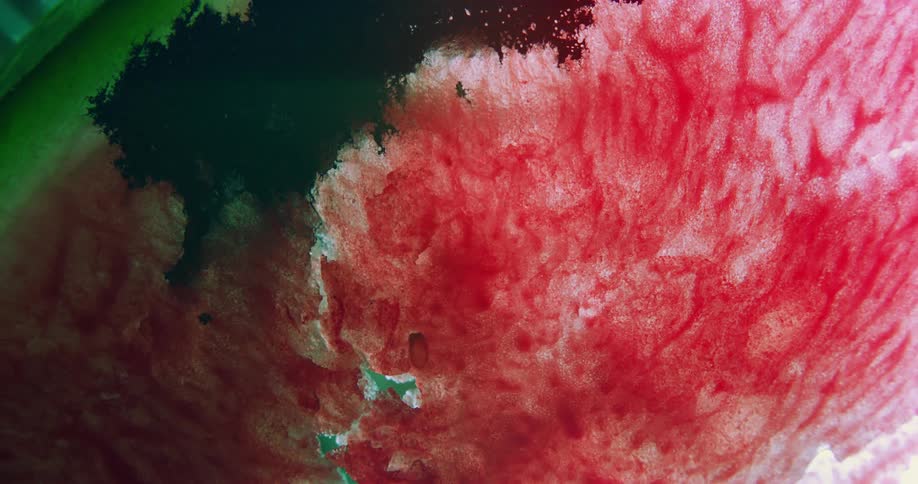 Red ink stains a surface covered in streaks of red