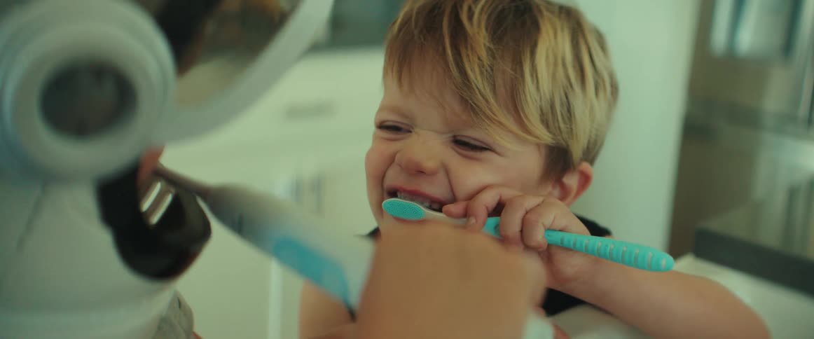Siblings brush their teeth together