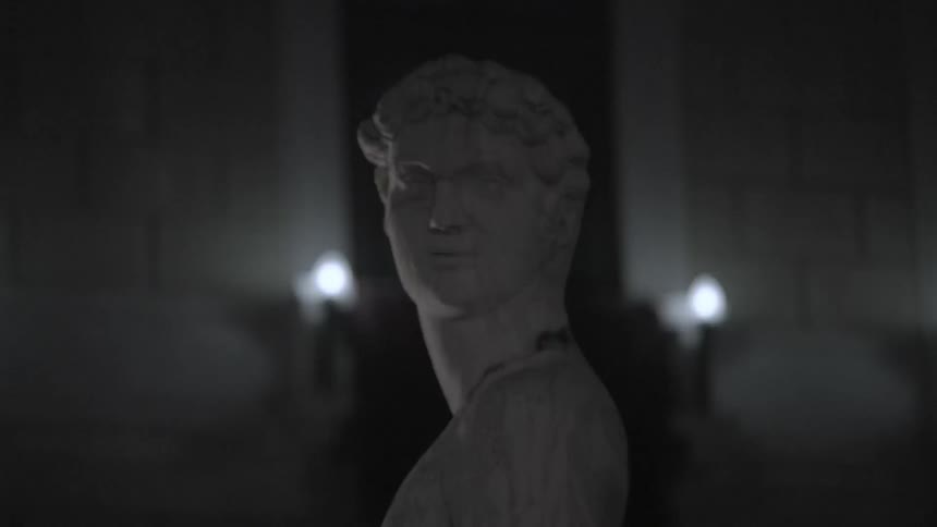 A statue of a man is in a dark area