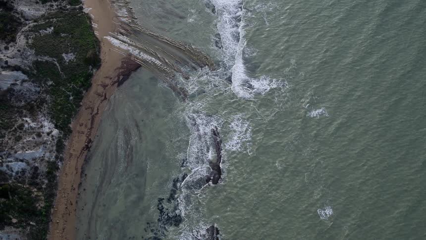 Overhead view of waters coming ashore on a beach