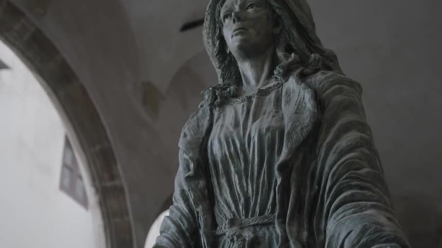 Old statue standing outside of a building