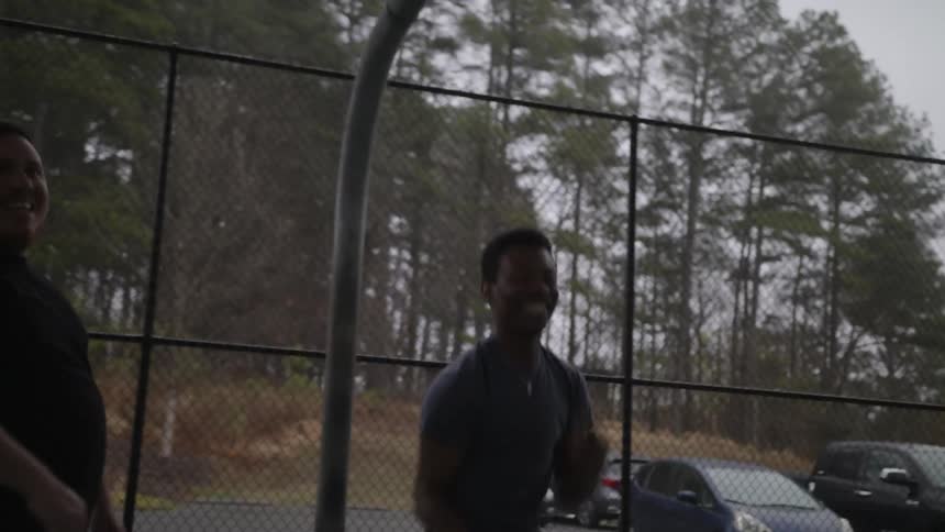 A group of men plays basketball in basketball court