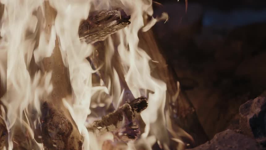 Wood is burning in this fire at night