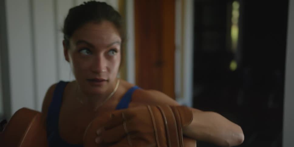 A woman is exercising with boxing gloves