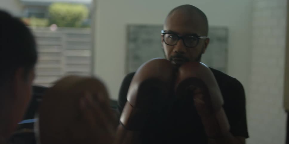 Man and woman are boxing together indoors