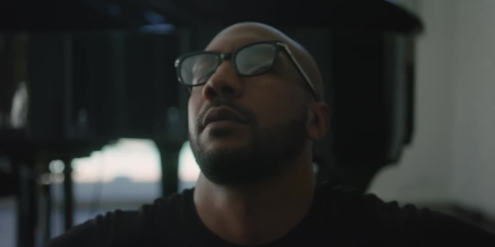 A man is sitting indoors and relaxing