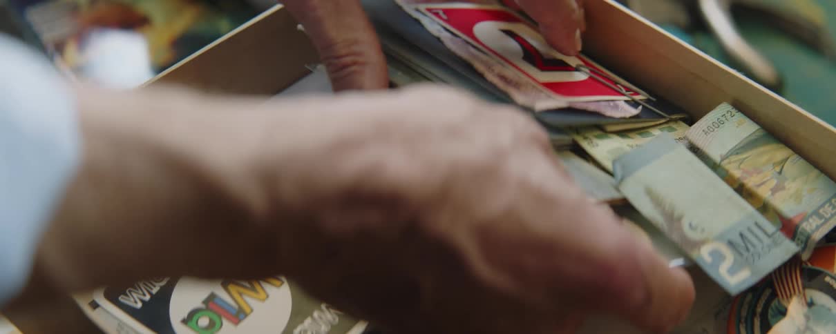 A man is searching through a box of items