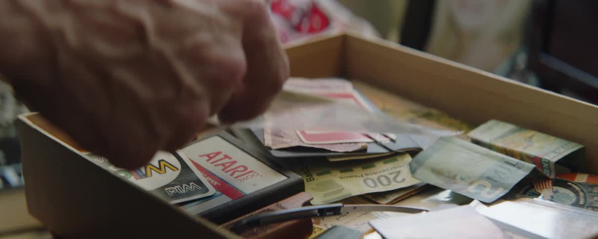 Someone is organizing stuff that is in a drawer indoors