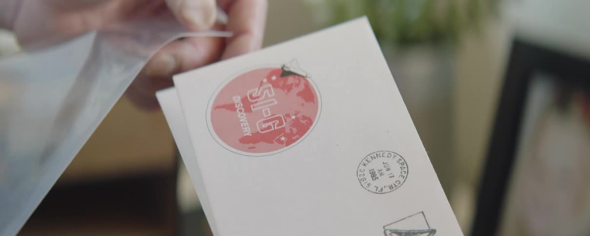 Close up of mans hands holding envelope with stamp