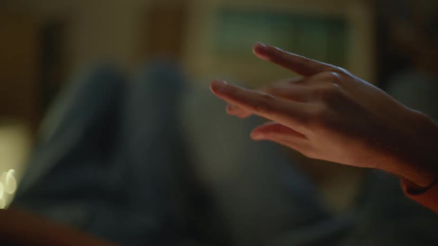 A person uses sign language to talk with another person