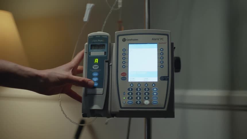 A person presses a button on a medical device
