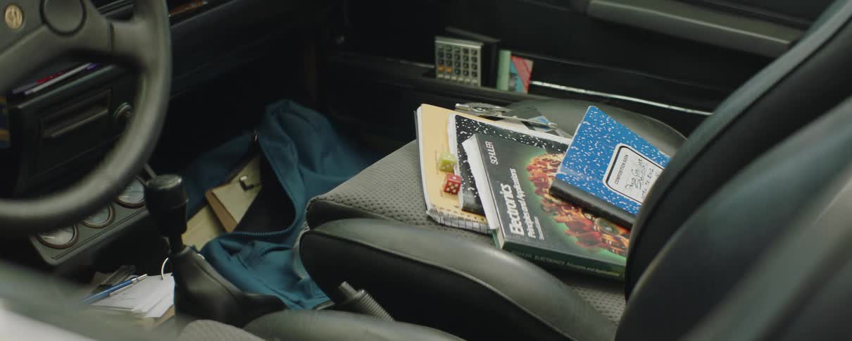 Books occupy passenger side seat and bag occupies foot area of empty vehicle