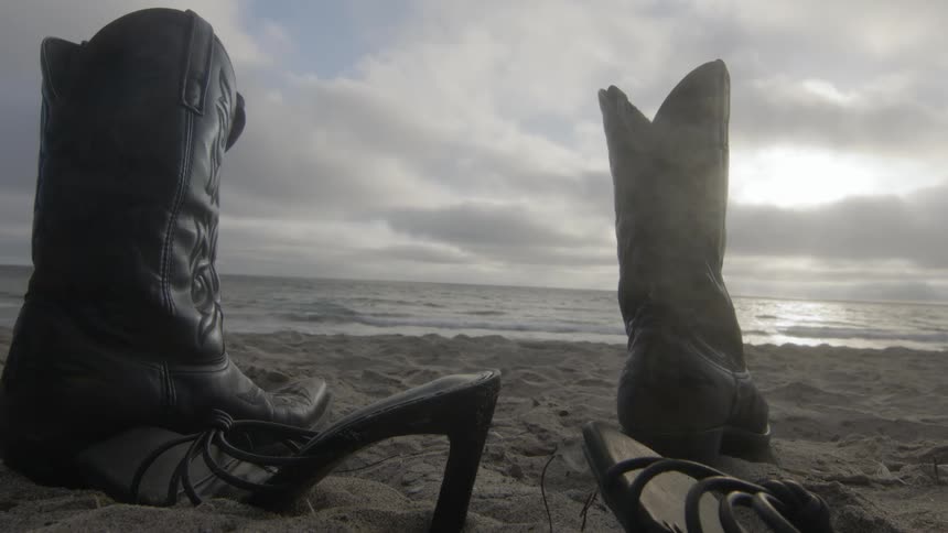 Shoes are left on the coast of the ocean