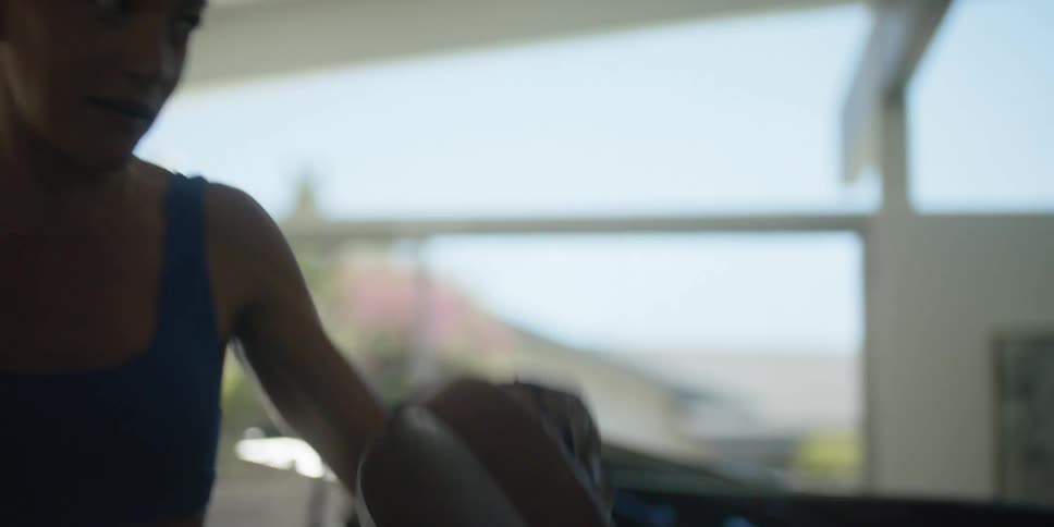 A man strikes the punch mitts being worn by a trainer