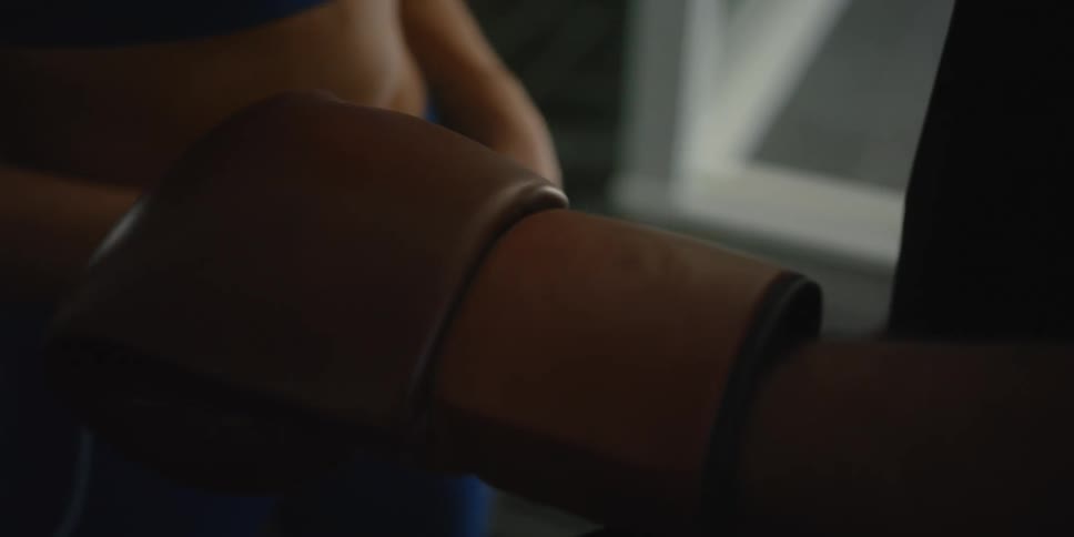 Man and woman are putting on boxing gloves