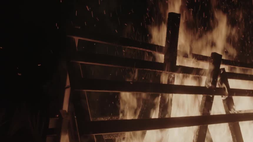 A fence burns at night