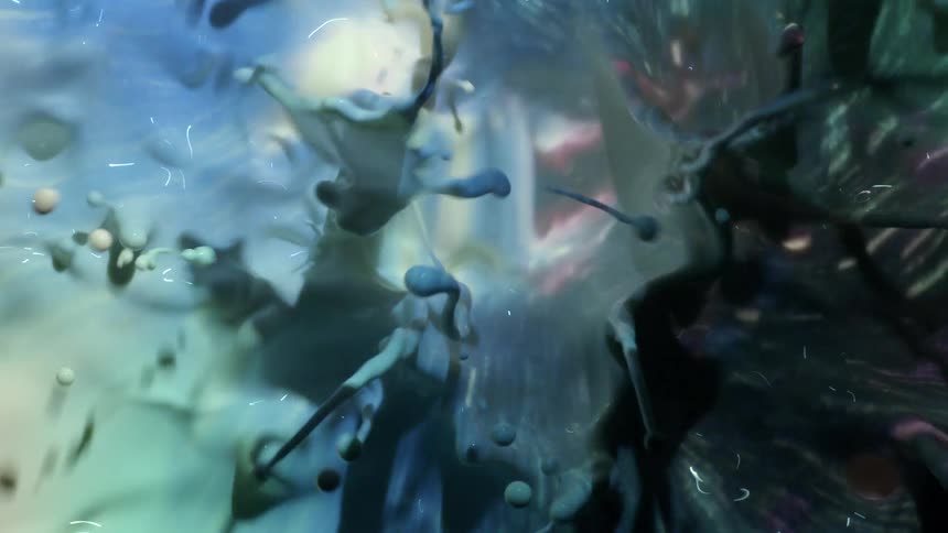 Purple and pink pastel colors reflect in a moving liquid as a black organic substance moves among the spheres