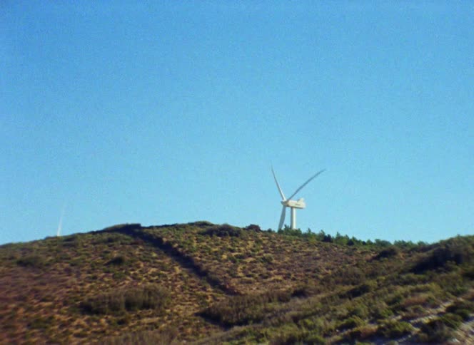 Wind turbines on wind farm producing electricity