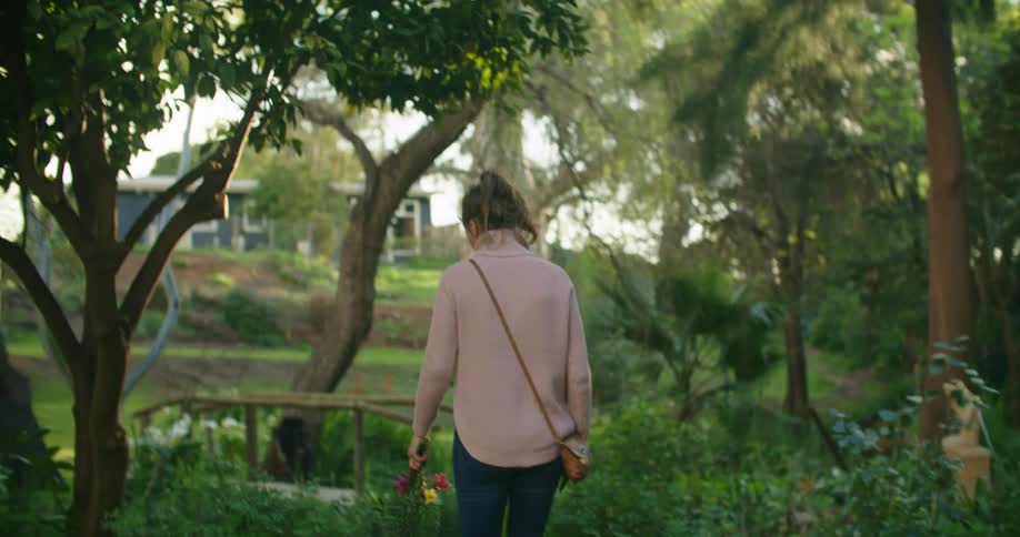 A woman is walking outdoors during the spring time
