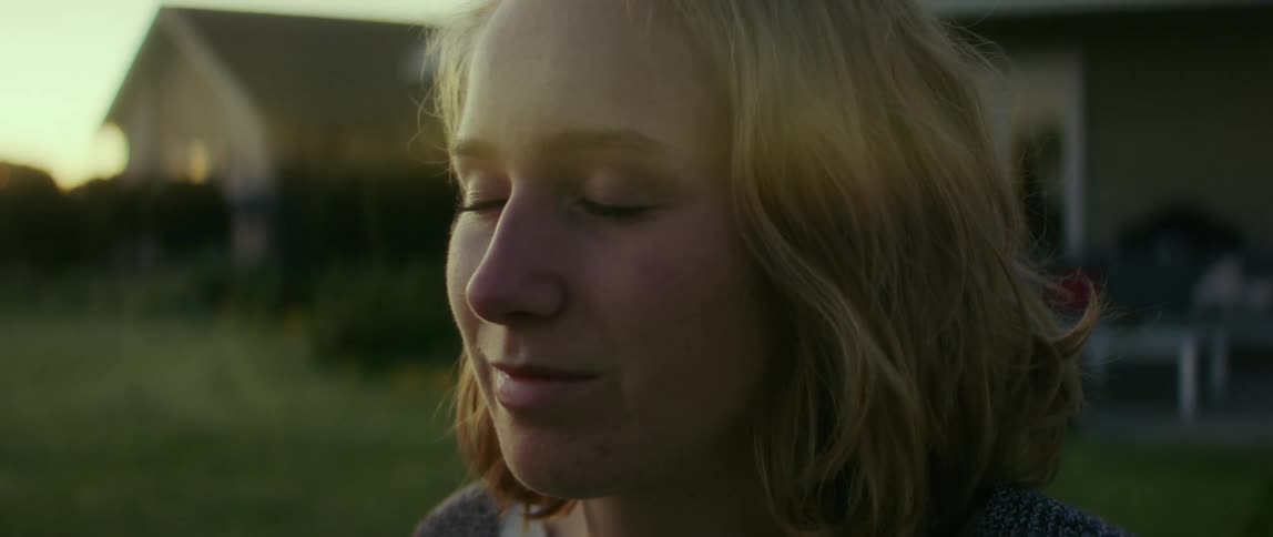 Side profile of happy blonde woman smiling in the countryside