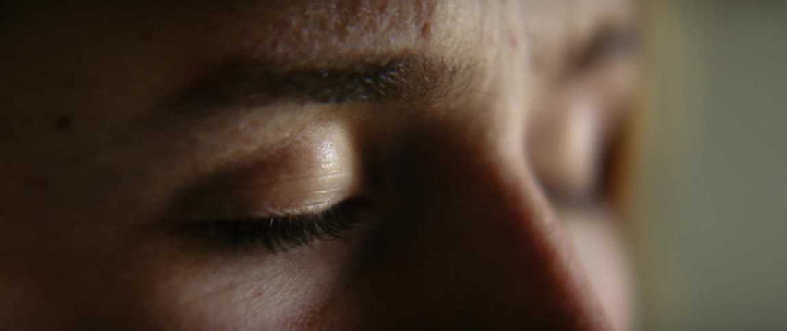 Side profile of womans eyes closing and opening eyes
