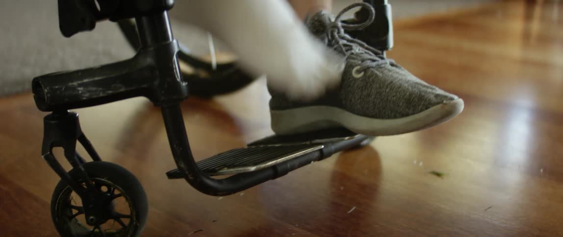 A person is sitting in a wheel chair indoors