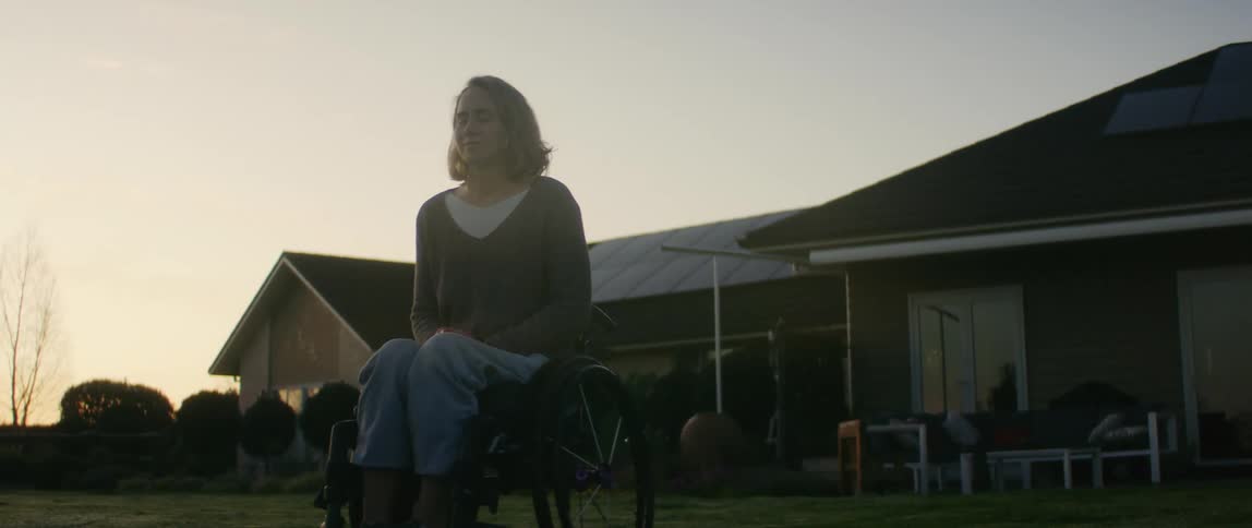 A woman in a wheelchair sitting outside
