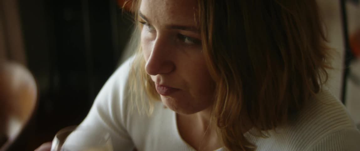 A woman drinking juice in a room
