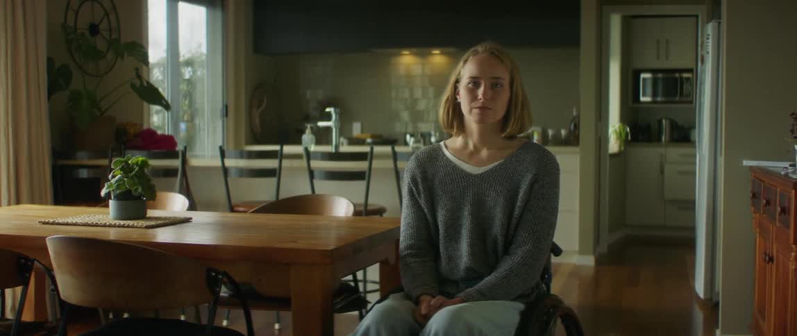 A woman is sitting on a chair indoors