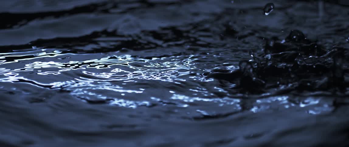 Rain is pouring into a body of water