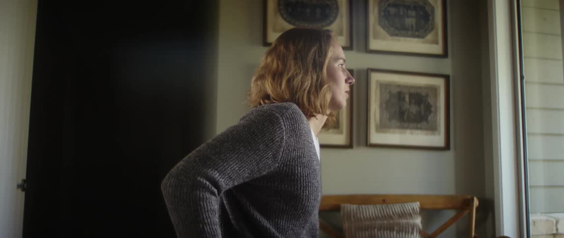 A woman is sitting in a chair indoors