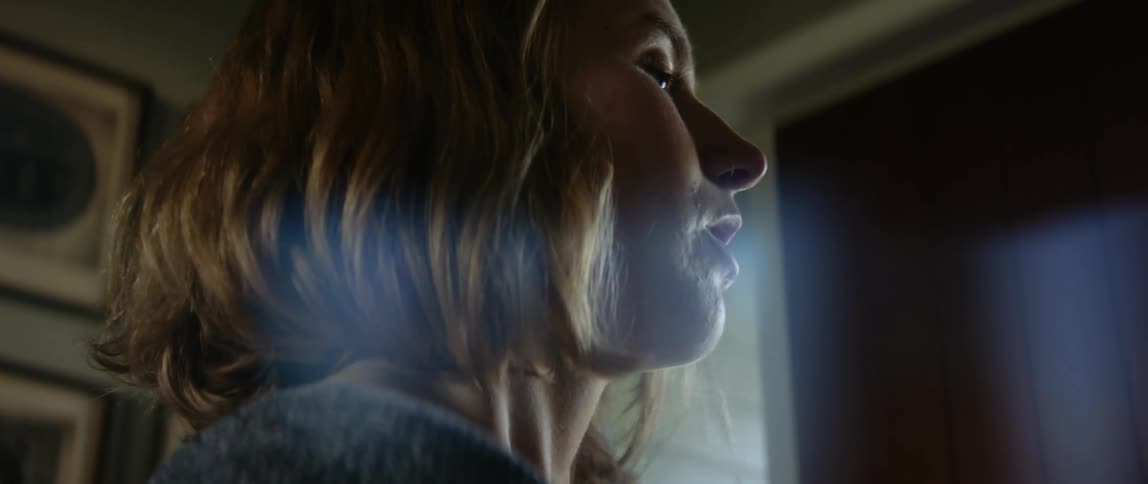 A woman is in her room by a door